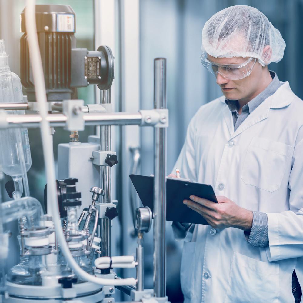 Technician working with industrial pharmaceutical equipment